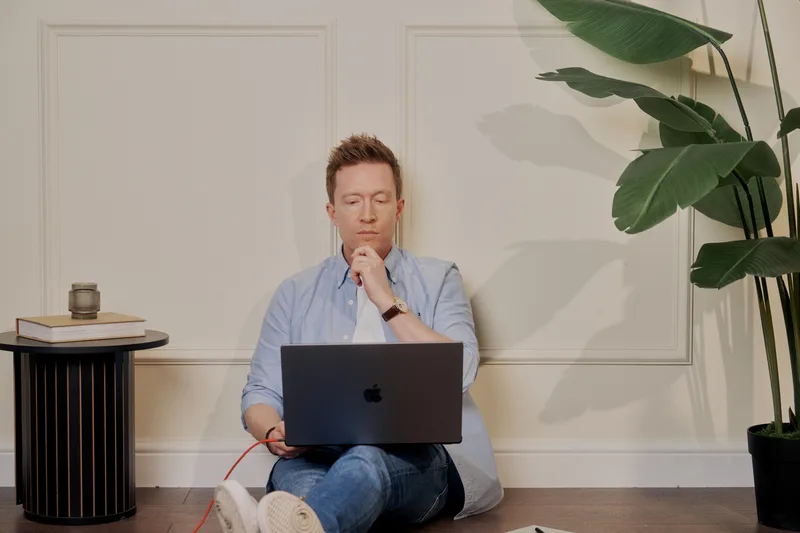 Olly Richards, business coach for online education entrepreneurs, working at his desk